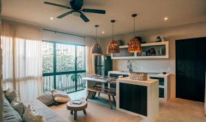 a living room with a kitchen with a couch and a table at Vida Jungle Apart 7 with special fee to access Hotel Bardo in Tulum