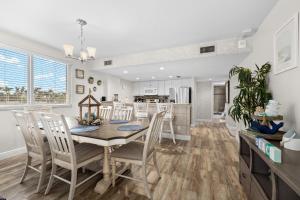 a kitchen and dining room with a table and chairs at Apollo #210 in Marco Island