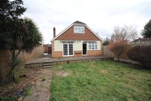 a house in a yard with a fence at Oaks House in Hanworth