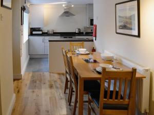 a kitchen and dining room with a wooden table and chairs at Old Milverton in Grassington