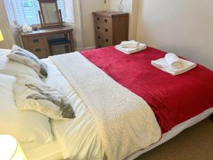 a bedroom with a bed with two towels on it at Old Milverton in Grassington