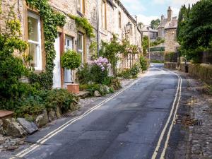 an empty street in a village with houses at Old Milverton in Grassington