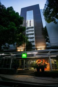 a tall building with a store in front of it at ibis Styles Belem Nazare in Belém