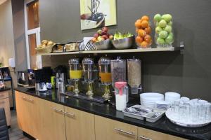 a kitchen with a counter with fruits and drinks at Hotel Columbus in Frankfurt/Main