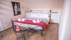a bedroom with a bed with presents on it at Little House in the centre Nettuno in Nettuno