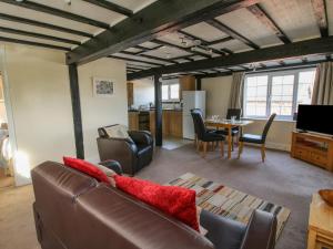 a living room with a couch and a table at Mill End in Nantwich