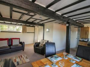 a living room with a table and chairs at Mill End in Nantwich