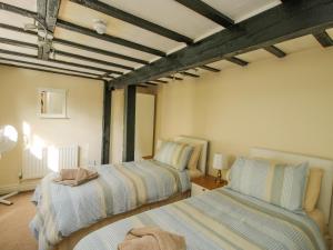 a bedroom with two beds in a room at Mill End in Nantwich