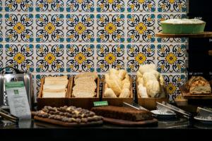 a display of breads and pastries in a bakery at ibis Styles Belem Nazare in Belém