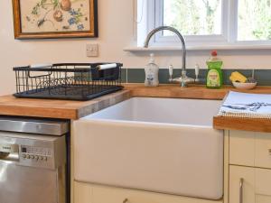 a kitchen with a large sink in a kitchen at South Downs Lodge in Droxford