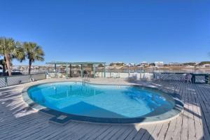 a large swimming pool on a wooden deck at Lei Lani Village 114 in Orange Beach