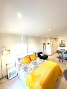 a bedroom with a large bed with yellow sheets at Gibraltar Central Suites in Gibraltar
