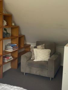 a living room with a couch and a book shelf at Bawley Point accommodation in Bawley Point