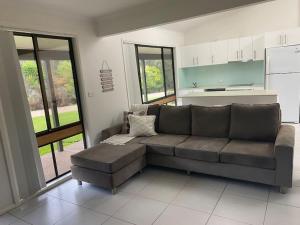 a living room with a couch and a table at Bawley Point accommodation in Bawley Point