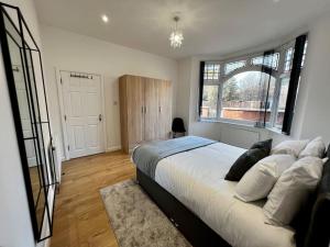 a bedroom with a large bed and a large window at Luxury Apartment in Nuneaton in Nuneaton