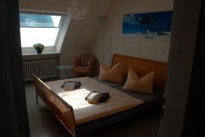 a bedroom with a bed with pillows and a window at Cantay-Mathildenstraße 16 - FW 3 - OG links in Fehmarn