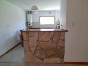 a kitchen with a stone counter with a sink at Estrella in Trevelin