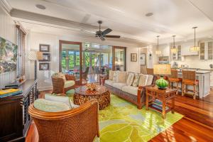 a living room with a couch and a table at The Lodge at Kukuiula - CoralTree Residence Collection in Koloa