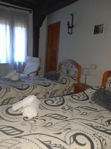 sypialnia z 2 łóżkami i kocem w obiekcie Hotel Rural Sierra de Francia w mieście Sotoserrano