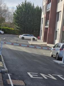 a street with cars parked in a parking lot at Luxury Modern, One bedroom flat in Solihull