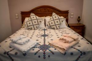 a bed with two towels and pillows on it at Dar El Karam Fez in Fez