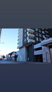 a large building in front of a building at Apart Hotel Bauerle & Apartamentos in Temuco