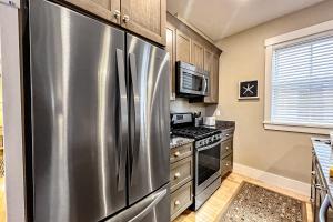 a kitchen with a stainless steel refrigerator and a stove at The Heart of the West End #3 in Portland