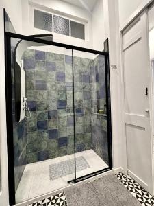 a shower with a glass door in a bathroom at Puerta Roja 3 bedroom Luxury Apartment in Málaga +9 photos