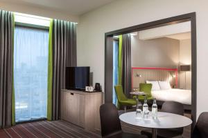 a hotel room with a bed and a table with a tv at Park Inn by Radisson Manchester City Centre in Manchester