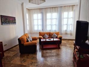 a living room with two couches and a coffee table at Apartamento El Duque - Plaza de las Tendillas in Córdoba