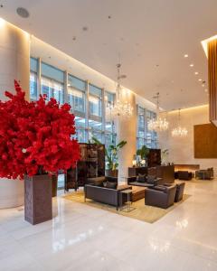 a lobby with couches and a large red plant at Shangri-La Vancouver in Vancouver