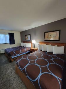 a hotel room with two beds in a room at SureStay Plus Hotel by Best Western Grand Island in Grand Island