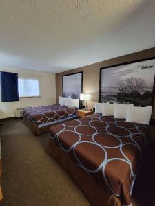 a hotel room with two beds in a room at SureStay Plus Hotel by Best Western Grand Island in Grand Island