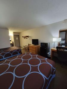 a hotel room with two beds and a flat screen tv at SureStay Plus Hotel by Best Western Grand Island in Grand Island