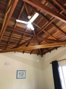 a ceiling fan in a room with wooden ceilings at Pousada Do Moinho in Nazaré Paulista