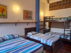 a room with two bunk beds in it at Hostal La Casa de Felipe in Taganga