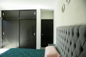 sypialnia z łóżkiem i czarną szafą w obiekcie TORRE CARRANZA w mieście Tequila