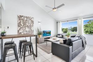 a living room with a couch and a table at Leumeah - A Modern Townhouse in Cairns in Cairns North +5 photos