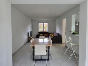 a dining room and living room with a table and chairs at Villa Bed & Garden in Brussels