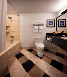 a bathroom with a toilet and a sink and a tub at New York New York in Las Vegas