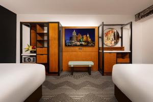 a room with a bed and a table and a shelf at New York New York in Las Vegas