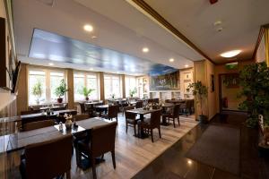 a dining room with tables and chairs in a restaurant at Hotel City Panorama in Hannover
