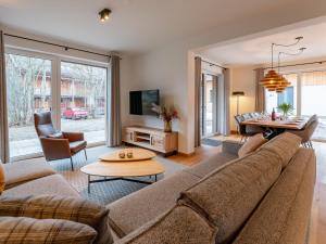a living room with a couch and a table at Mountain Chalet Alpinchique 2 in Sankt Lorenzen ob Murau