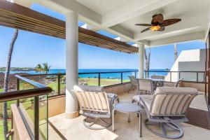 a balcony with chairs and a view of the ocean at Mauna Lani Point in Waikoloa