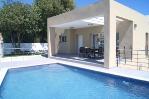 a villa with a swimming pool and a house at Pomera I - BTB in Beniarbeig