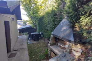 a backyard with a stone fireplace in a yard at Casita Cavok in San Carlos de Bariloche