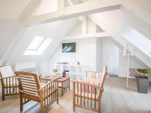 a room with chairs and a table in a attic at Calm and comfortable apartment in Bayeux, 9km from the beach in Bayeux