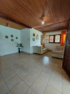 Hostel Raíces Salta في سالتا: غرفة معيشة كبيرة مع سقف خشبي