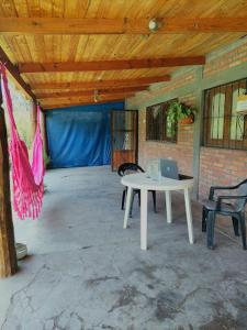 a room with a table and two chairs and a laptop at Hostel Raíces Salta in Salta