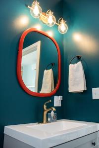 a bathroom with a red mirror and a sink at Bischoff Inn - Former 1870 Furniture Factory Now 5 Room Boutique Hotel 